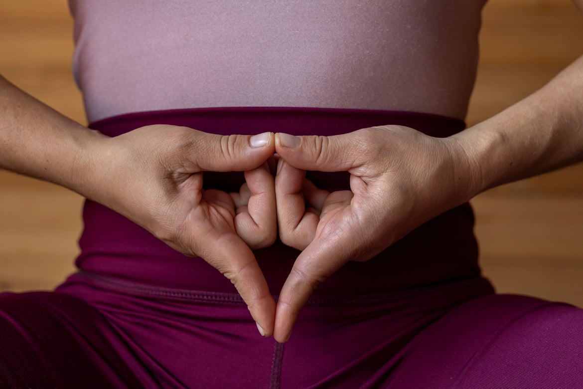 Closeup of a pair of hands doing the Yoni Mudra gesture of Yoga